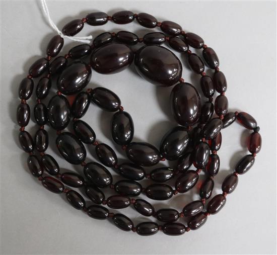 A single strand graduated simulated cherry amber bead necklace, 118cm.
